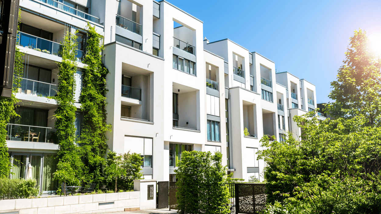 Modern apartment for rent in Gurgaon featuring contemporary architecture, balconies, and lush green surroundings