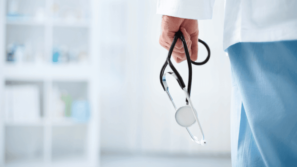 A smiling medical professional in a modern clinic, showcasing the proximity to top-tier doctors for residents of coliving spaces in Bangalore.