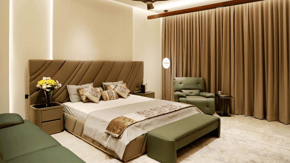 Coliving spaces for rent on GCR Road featuring a luxury furnished bedroom with a geometric headboard, olive green ottoman, and premium interior design.