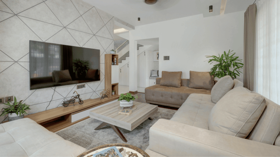 Fully furnished living room with a modern sofa and TV unit in a premium room for rent in HSR Layout, Bangalore.