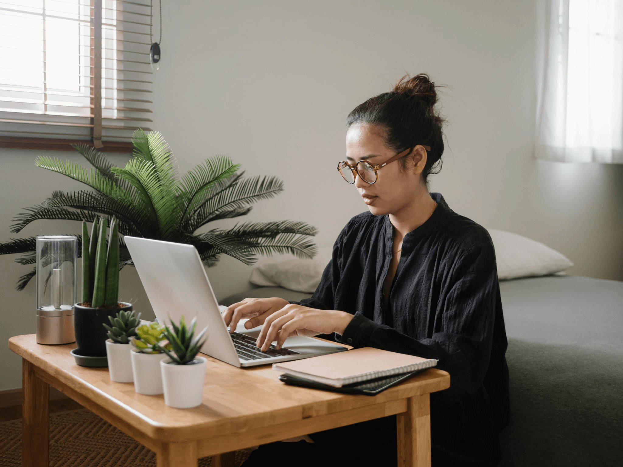 Young professional working on a laptop inside a modern fully furnished flat for rent in Koramangala.
